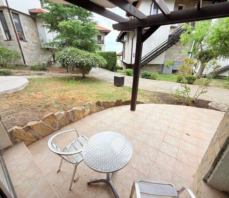 Outdoor terrace with garden and trees in Bay View Villas, Kosharitsa, Bulgaria.