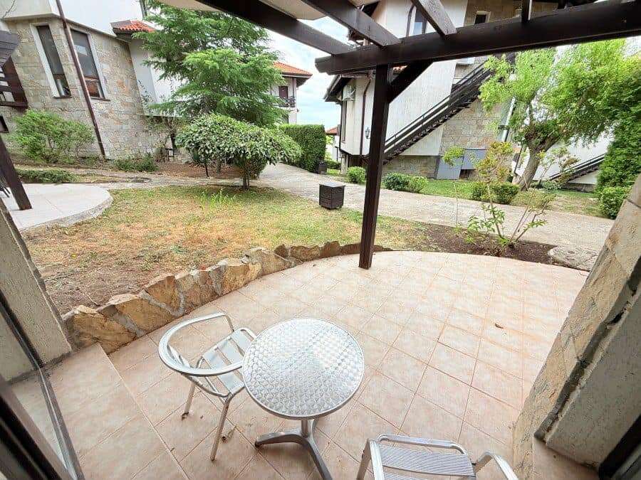 Outdoor terrace with garden and trees in Bay View Villas, Kosharitsa, Bulgaria.