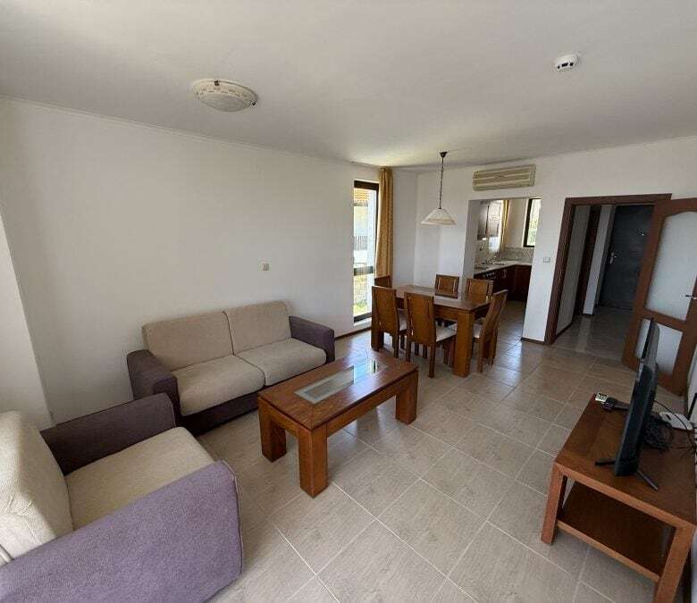 Spacious living room with comfortable sofas and a dining area in Bay View Villas, Kosharitsa, Bulgar.
