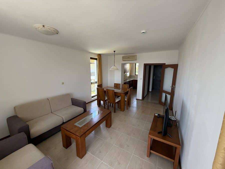 Spacious living room with seating area and dining space, close to the sea in Bulgaria.
