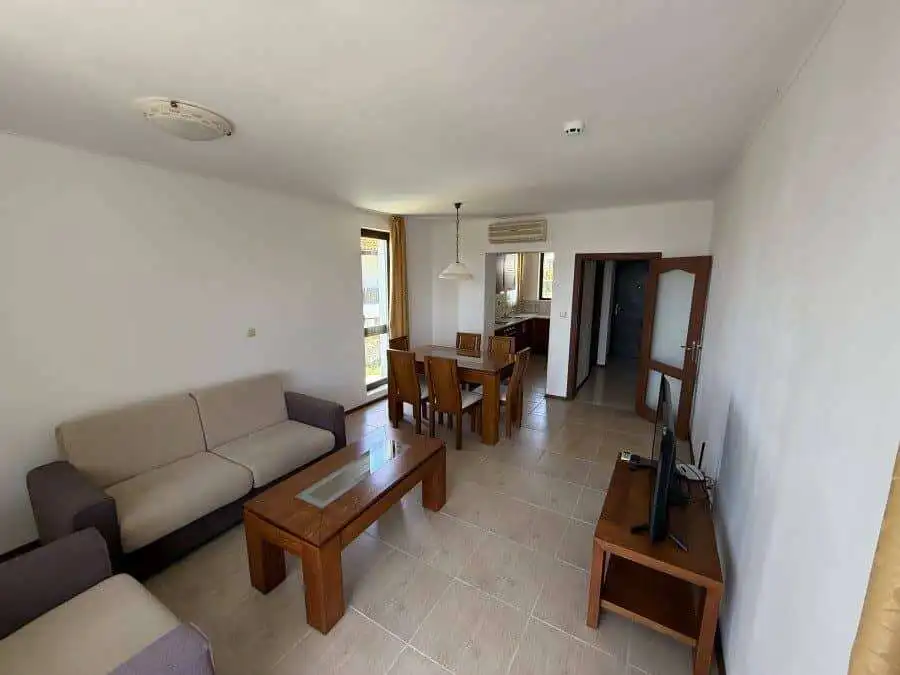 Spacious living room with seating area and dining space, close to the sea in Bulgaria.