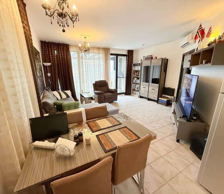 Bright living room with modern furnishings and large windows.