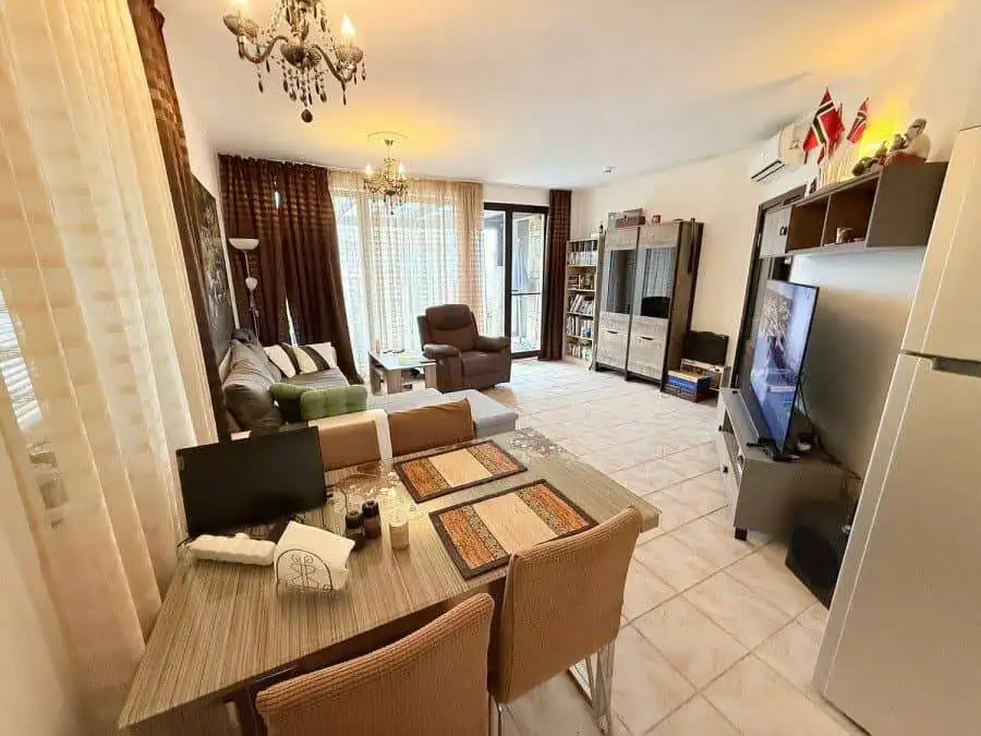Bright living room with modern furnishings and large windows.