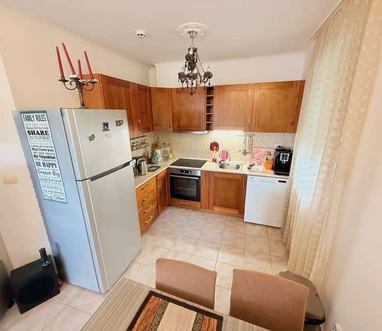 Bright kitchen with wooden cabinets and modern appliances.