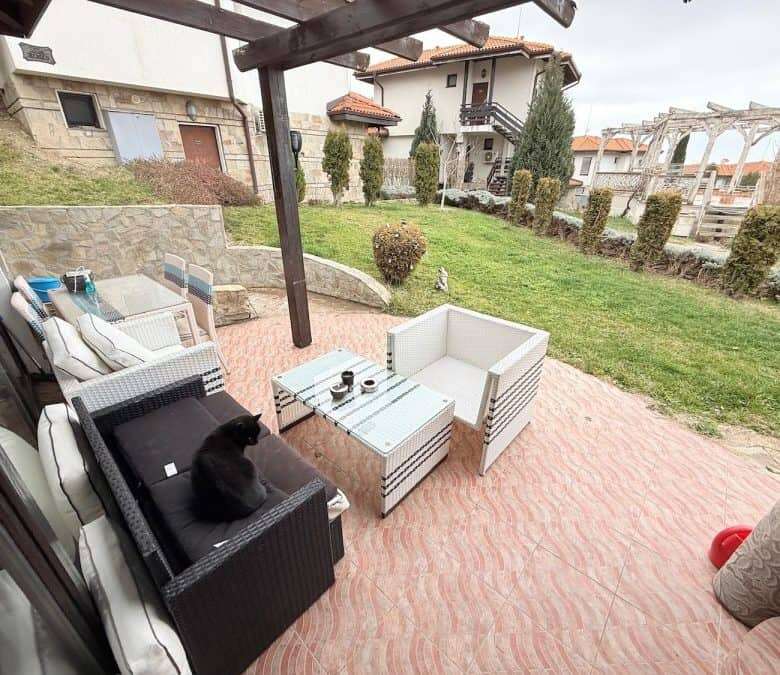 Outdoor patio with comfortable furniture and garden view in Bay View Villas, Bulgaria.