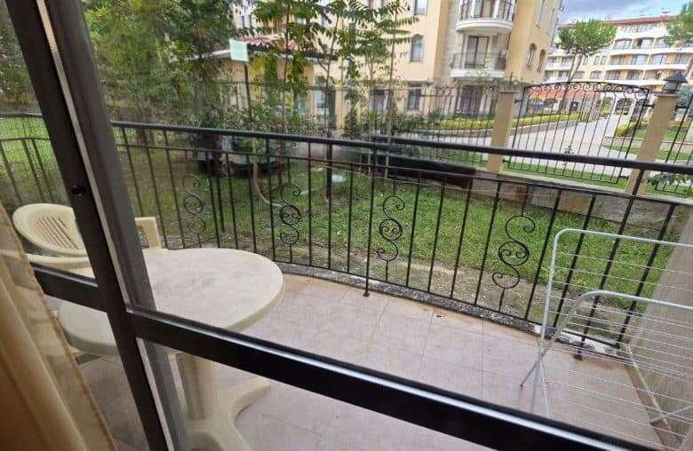 Balcony view of Avalon**** in Sunny Beach with outdoor seating and garden scenery.