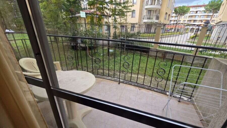 Balcony view of Avalon**** in Sunny Beach with outdoor seating and garden scenery.