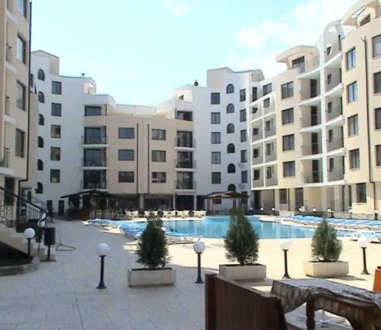Modern Avalon Sunny Beach apartment complex with pool and landscaped courtyard.