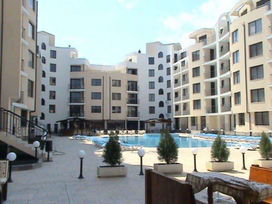 Modern Avalon Sunny Beach apartment complex with pool and landscaped courtyard.