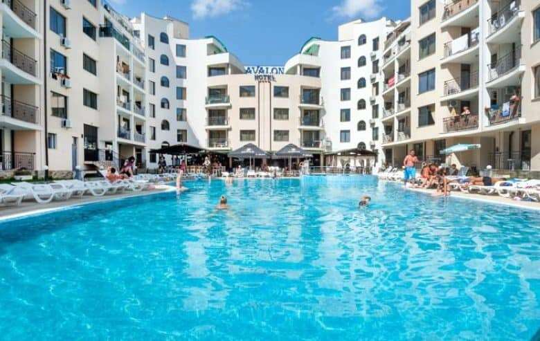 Modern apartment complex with large outdoor pool at Avalon Sunny Beach.