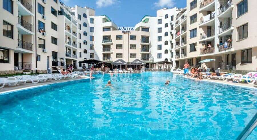 Modern apartment complex with large outdoor pool at Avalon Sunny Beach.