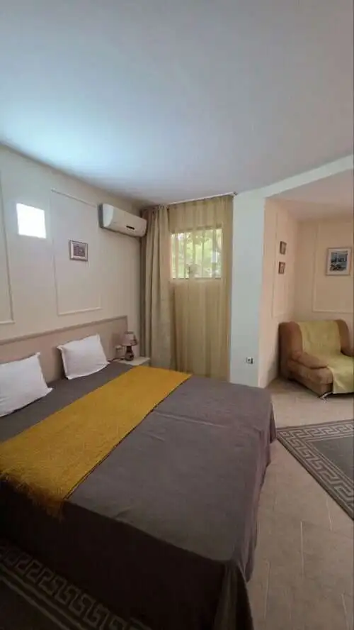 Cozy bedroom in Avalon Sunny Beach Comfortable bedroom with double bed, beige curtains, and modern decor in Avalon Sunny Beach.