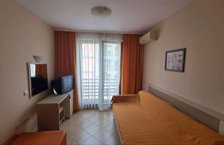 Interior view of a cozy studio apartment with a double bed and balcony in Royal Sun, Sunny Beach.