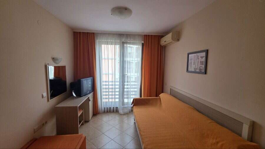 Interior view of a cozy studio apartment with a double bed and balcony in Royal Sun, Sunny Beach.