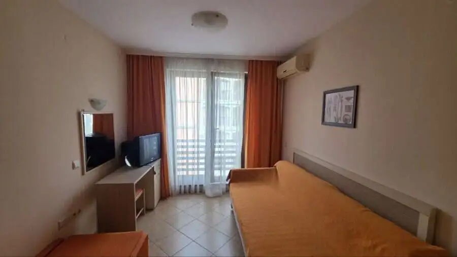 Interior view of a cozy studio apartment with a double bed and balcony in Royal Sun, Sunny Beach.