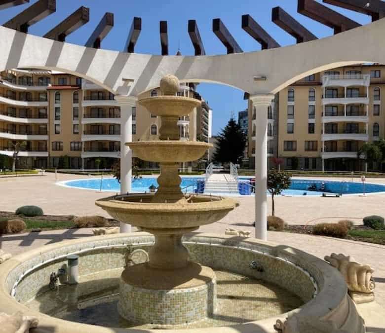 Beautiful apartment complex with outdoor pool and elegant fountain in Sunny Beach.