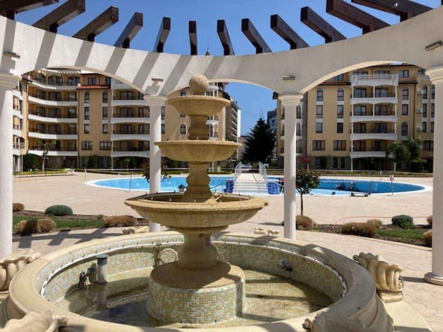 Beautiful apartment complex with outdoor pool and elegant fountain in Sunny Beach.