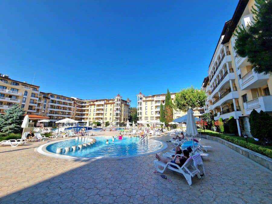 Bright outdoor pool area at Royal Sun complex, close to the sea.