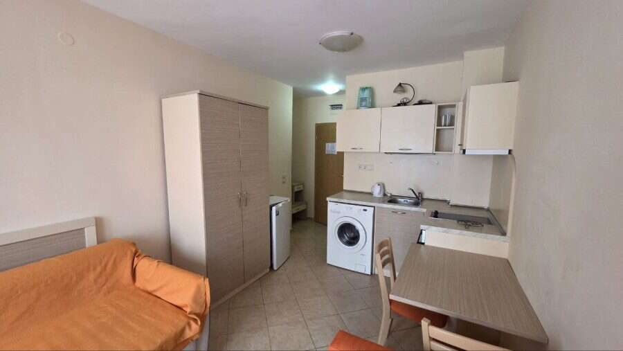 Compact studio apartment interior with kitchenette and sleeping area in Royal Sun.