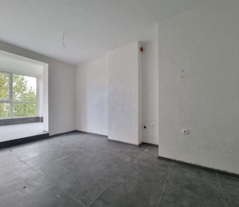 Floor apartment interior with large window and bright ambiance.