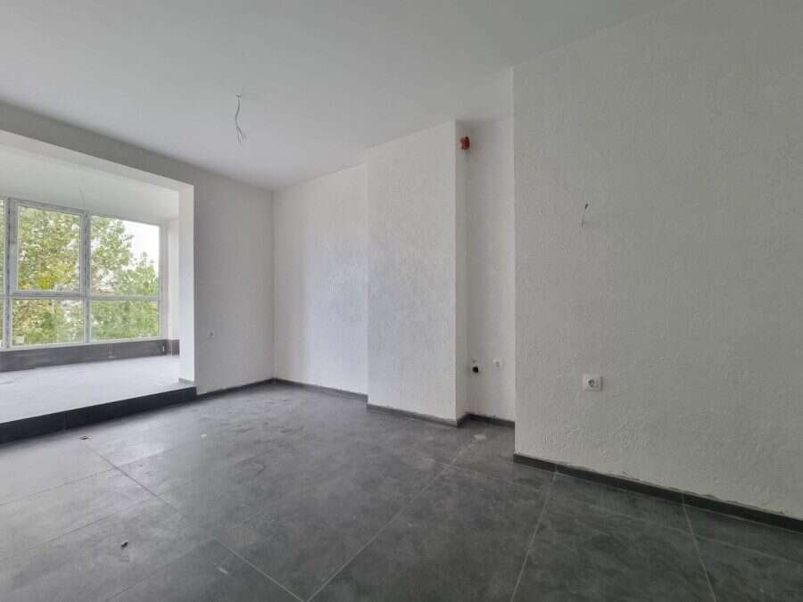 Floor apartment interior with large window and bright ambiance.