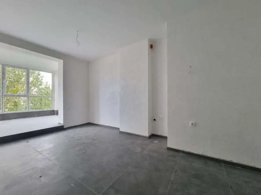 Floor apartment interior with large window and bright ambiance.