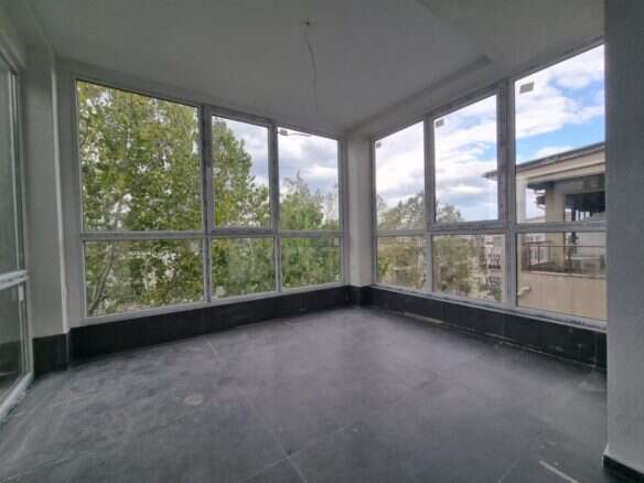 Floor apartment balcony overlooking trees and nearby buildings in Sunny Beach.