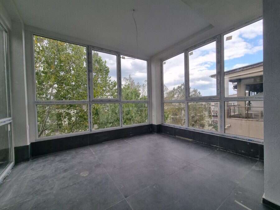 Floor apartment balcony overlooking trees and nearby buildings in Sunny Beach.