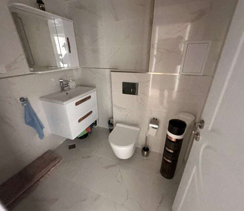 Bright bathroom of a 2-bedroom apartment near Sunny Beach with pool views, modern fixtures, and marb.