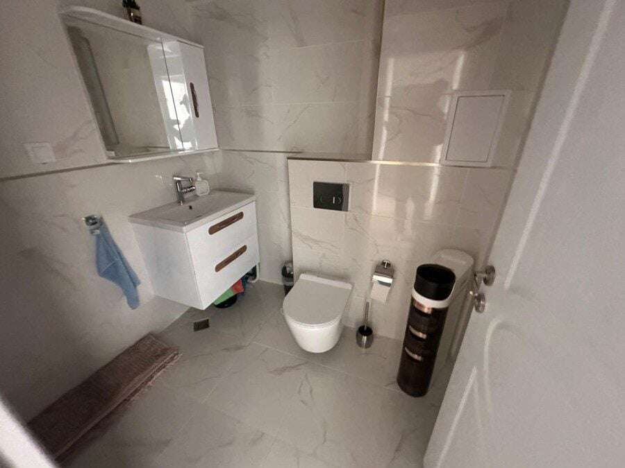 Bright bathroom of a 2-bedroom apartment near Sunny Beach with pool views, modern fixtures, and marb.