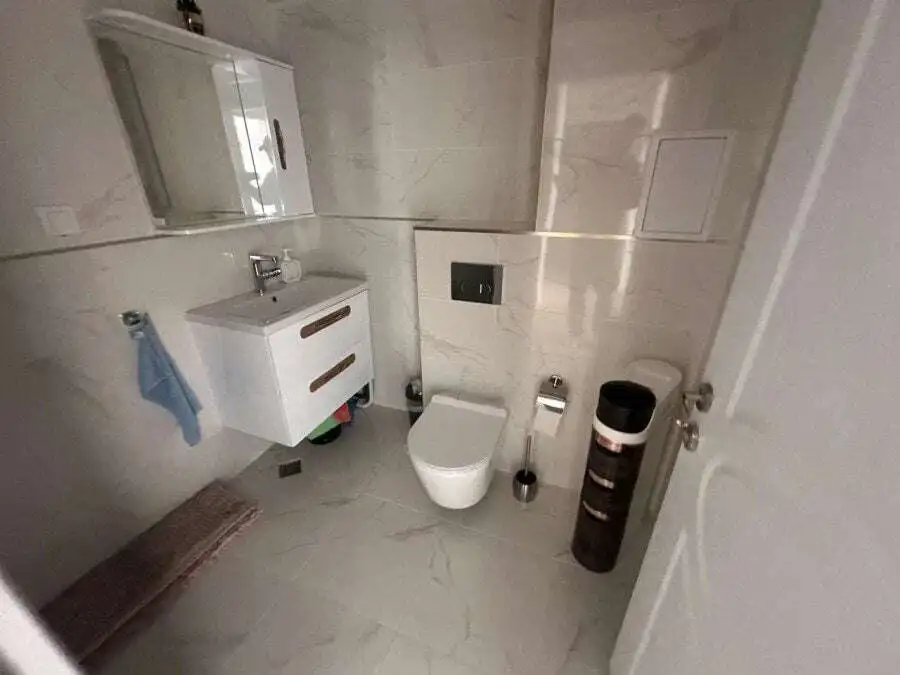 Bright bathroom of a 2-bedroom apartment near Sunny Beach with pool views, modern fixtures, and marb.