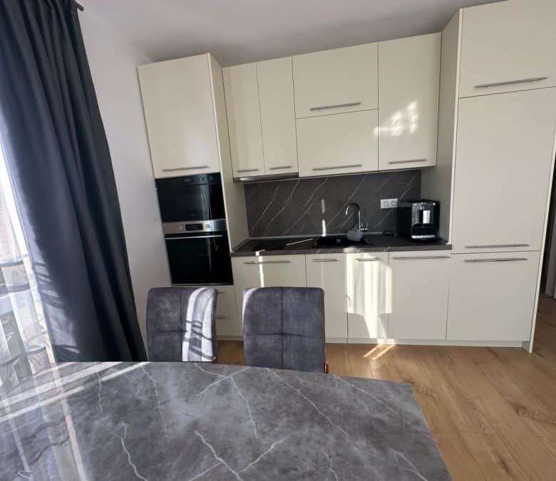 Modern kitchen with white cabinets and black countertops in a 2-bedroom apartment close to Sunny Bea.