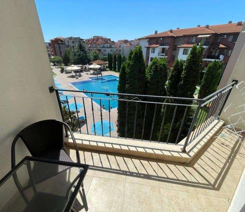 Balcony view of pool and garden from a 3-bedroom apartment in Apollon 5.