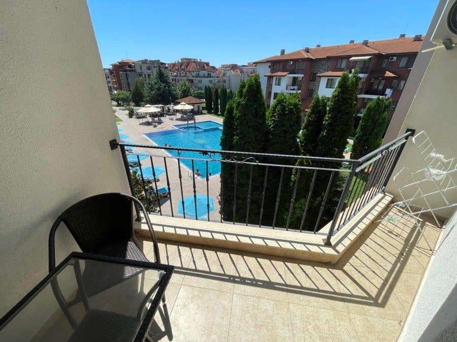 Balcony view of pool and garden from a 3-bedroom apartment in Apollon 5.