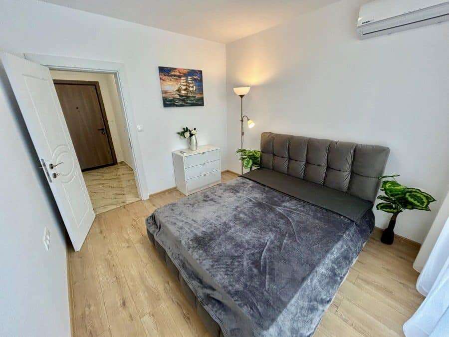 Apartment with pool views in Aphrodite Green, Sunny Beach, featuring modern decor and a spacious bed.