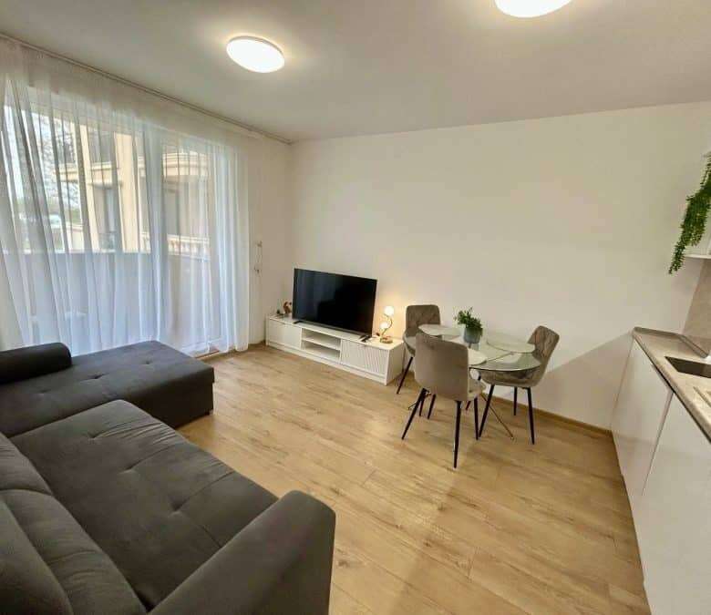 Bright living room with large windows and pool view in Aphrodite Green, Sunny Beach.