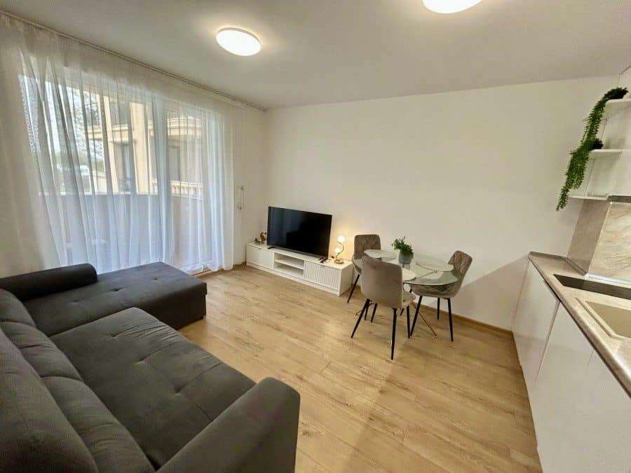 Bright living room with large windows and pool view in Aphrodite Green, Sunny Beach.
