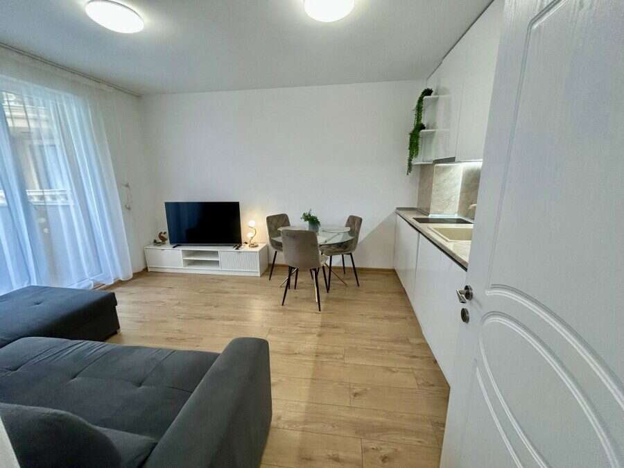 Apartment with pool views, modern interior, and open-plan living space in Aphrodite Green, Sunny Bea.