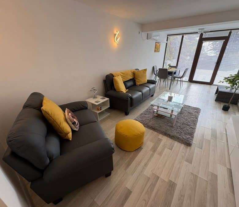 Bright living room of a 2-bedroom ground floor apartment in Sveti Vlas with stylish furniture and la.