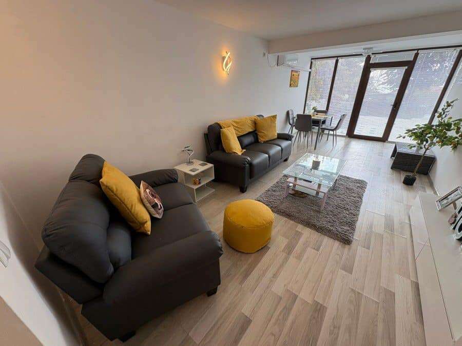 Bright living room of a 2-bedroom ground floor apartment in Sveti Vlas with stylish furniture and la.