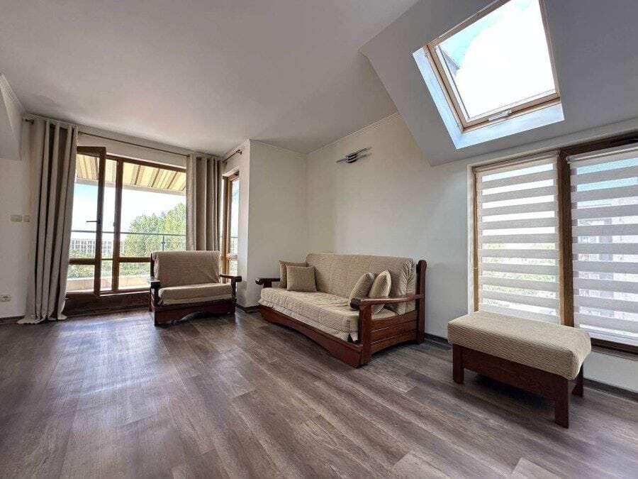 Bright top-floor apartment with spacious living area, large windows, and balcony in Sunny Beach.