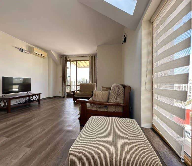 Bright top floor apartment with spacious living area, large windows, and balcony in Sunny Beach.