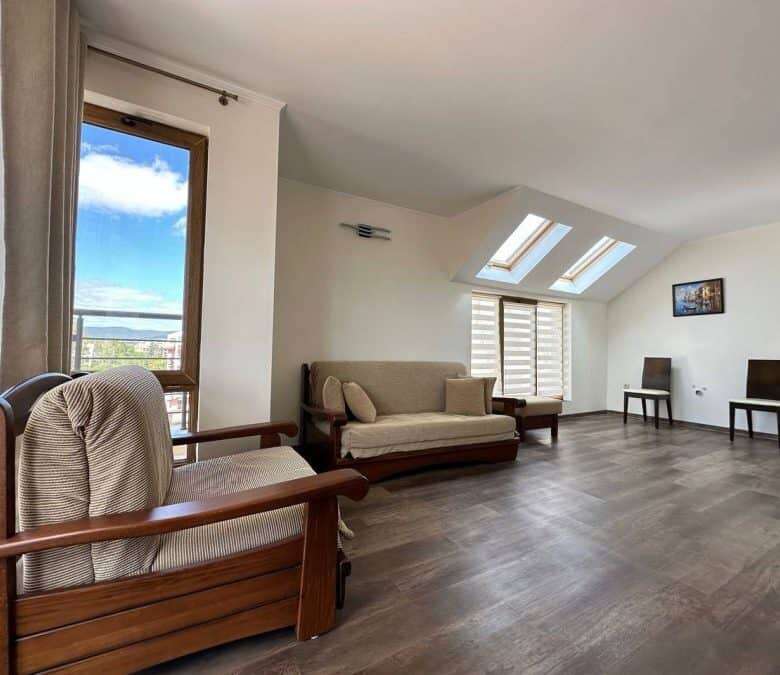 Spacious living area with comfortable seating, natural light, and scenic views.