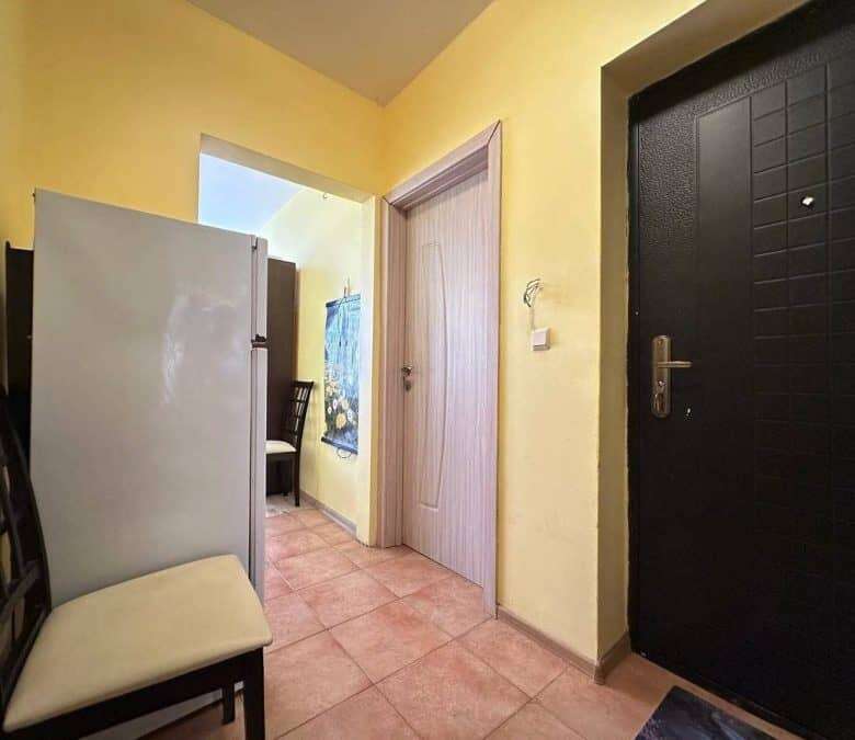 Interior view of a small 1-bedroom apartment in Nessebar, 300m from the sea, with simple furnishings.