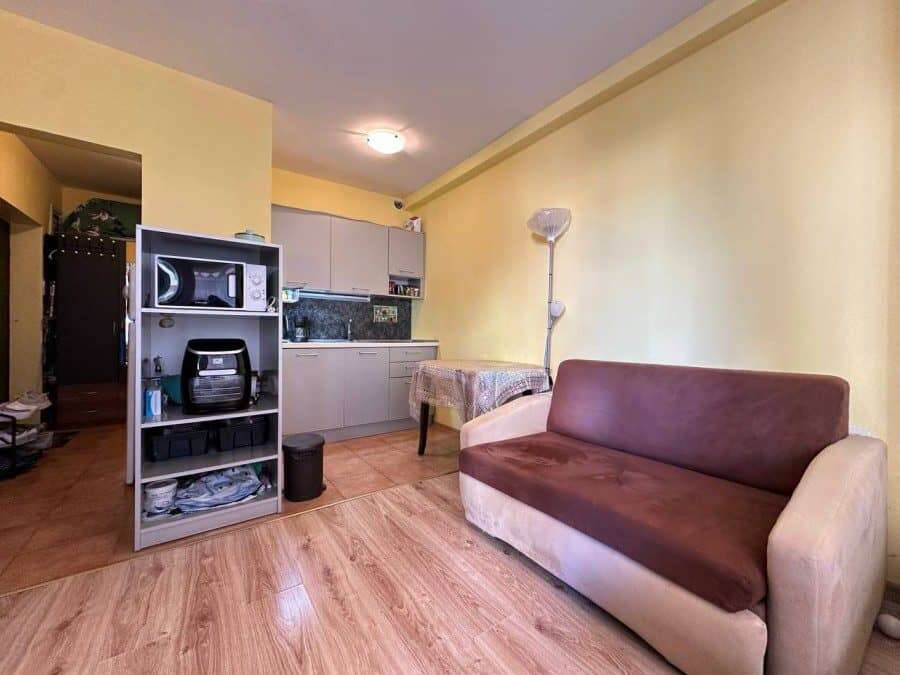 Apartment interior with living area, kitchenette, and sofa in Nessebar, 300m from the sea.