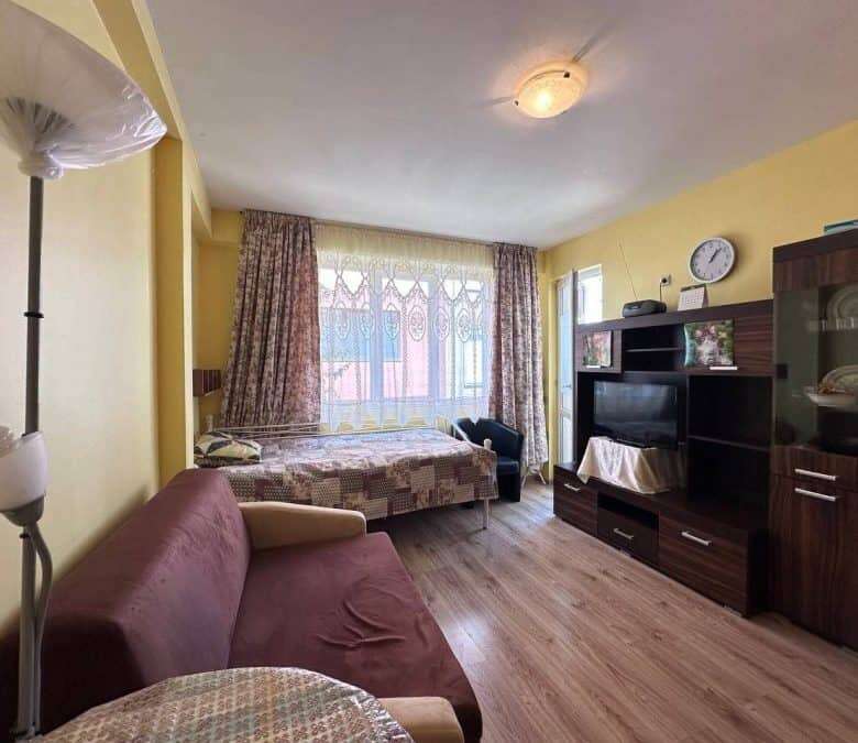 Interior view of a 1-bedroom apartment in Nessebar, near the sea, with living area and bedroom.