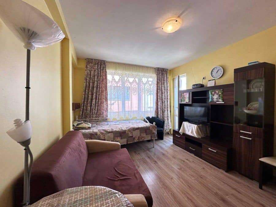 Interior view of a 1-bedroom apartment in Nessebar, near the sea, with living area and bedroom.