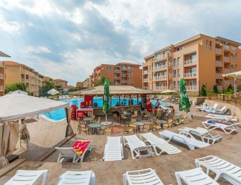 Pool area with sun loungers and umbrellas at Sunny Day 6 in Sunny Beach, Bulgaria.