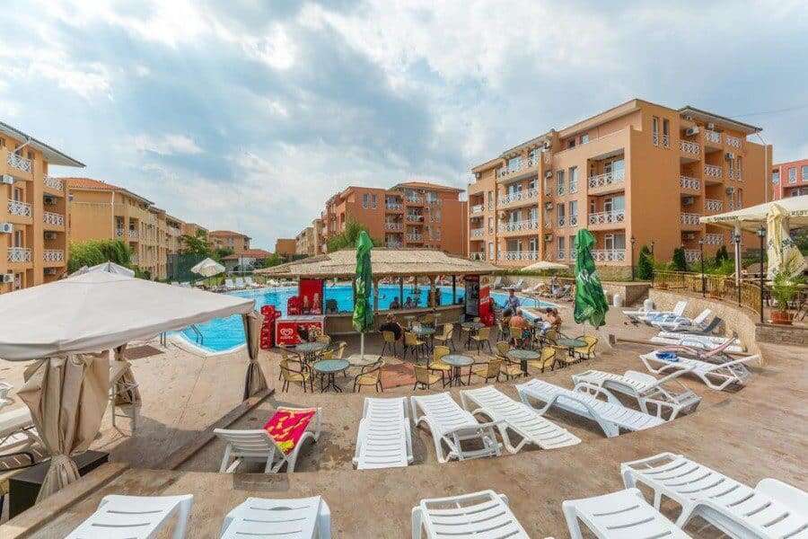 Pool area with sun loungers and umbrellas at Sunny Day 6 in Sunny Beach, Bulgaria.