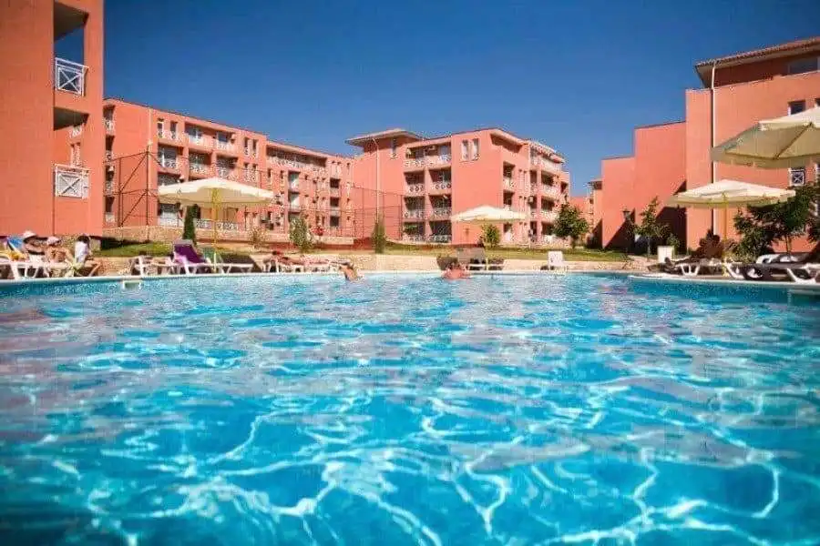 Bright outdoor pool area at a sunny residential property.